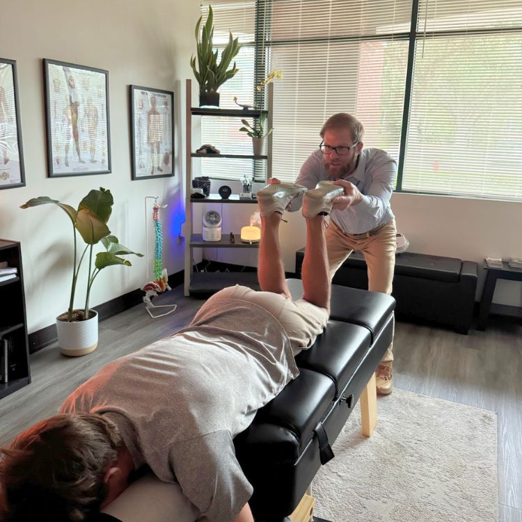 Dr. Sean Olenek doing applied kinesiology on patient