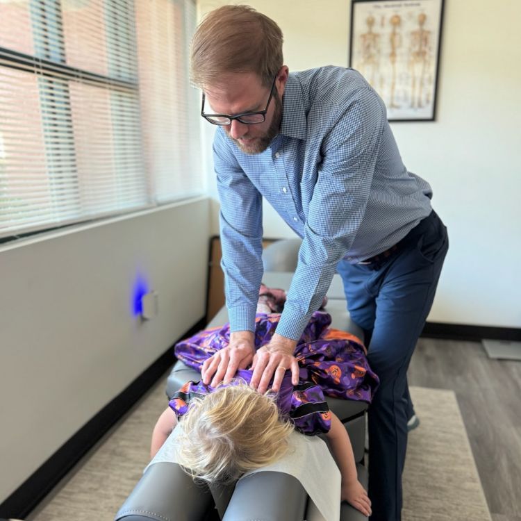 dr olenek performing chiropractic on a child