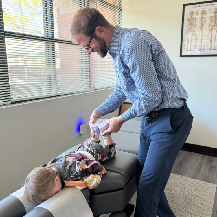 dr olenek performing chiropractic on a child